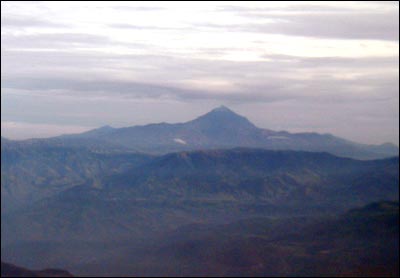 Silueta del volc�n Cotacachi desde la ventanilla del avi�n al amanecer